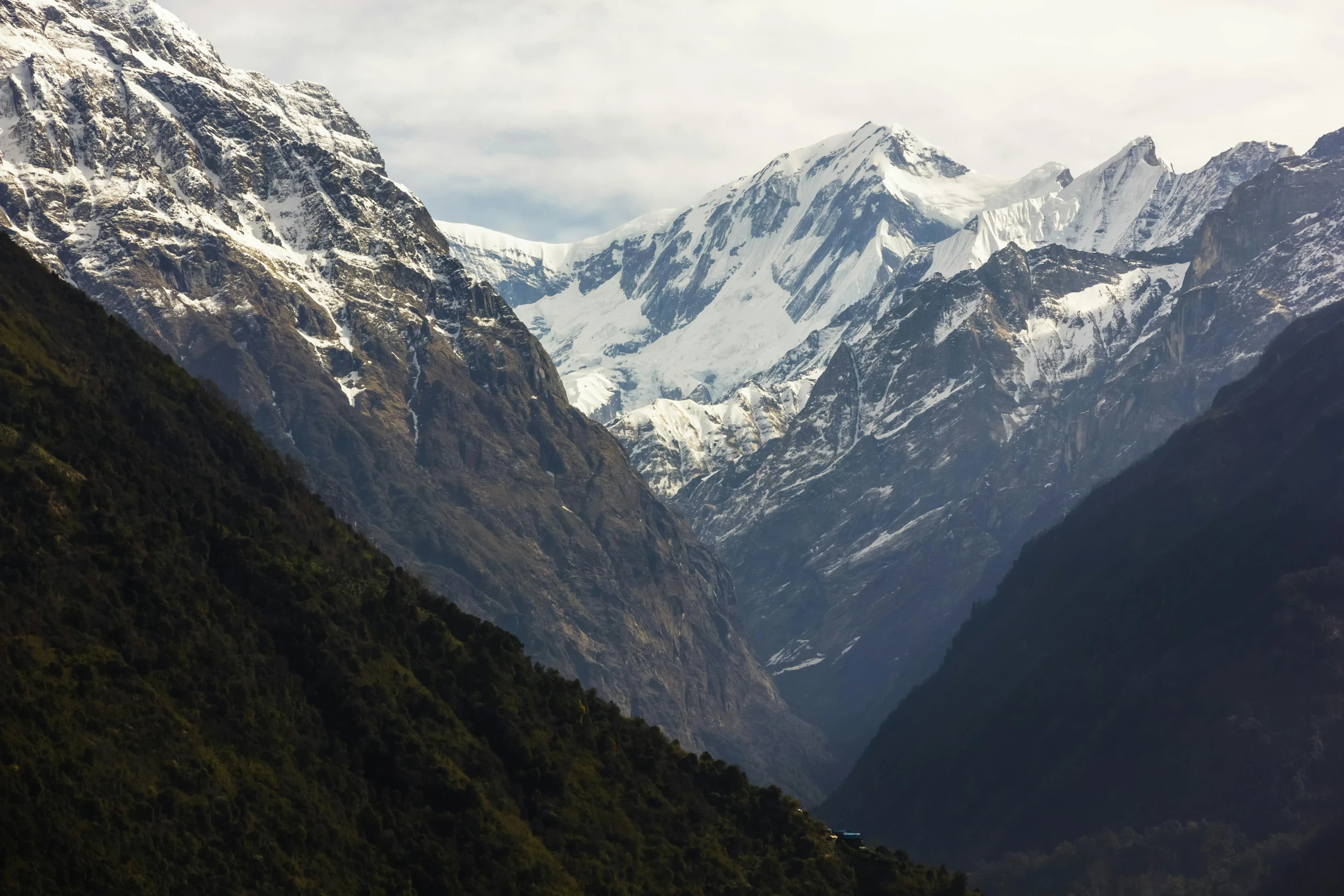 an overview of the snow covered mountains of a valley