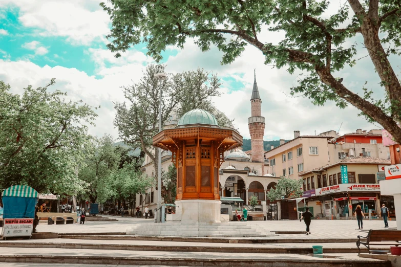 people sitting at benches in front of large stone buildings