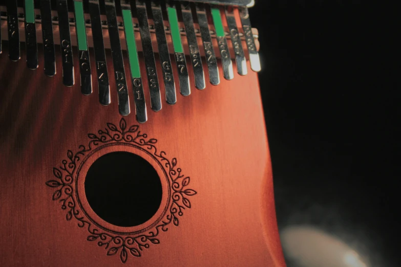 a wooden instrument with bells and a black hole