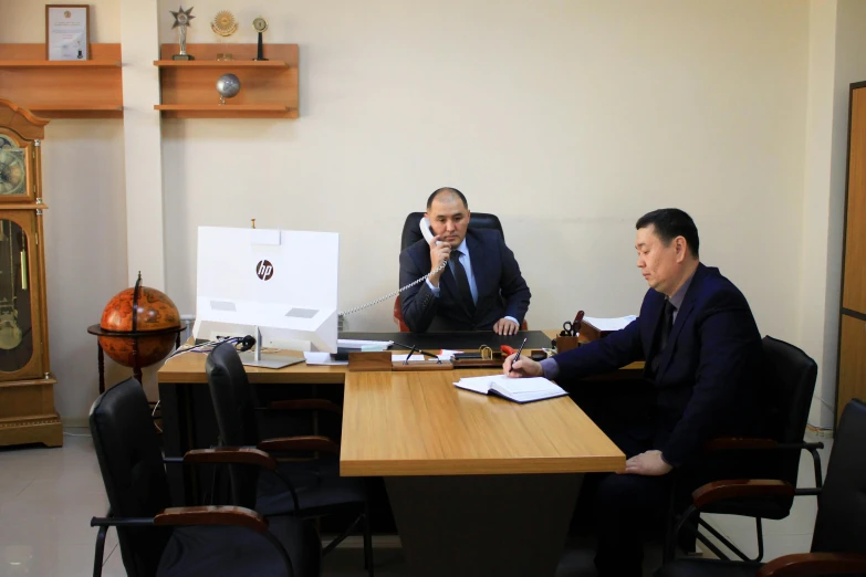 two men sitting in a business meeting having a discussion