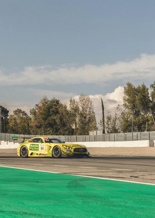 a yellow car driving on a race track