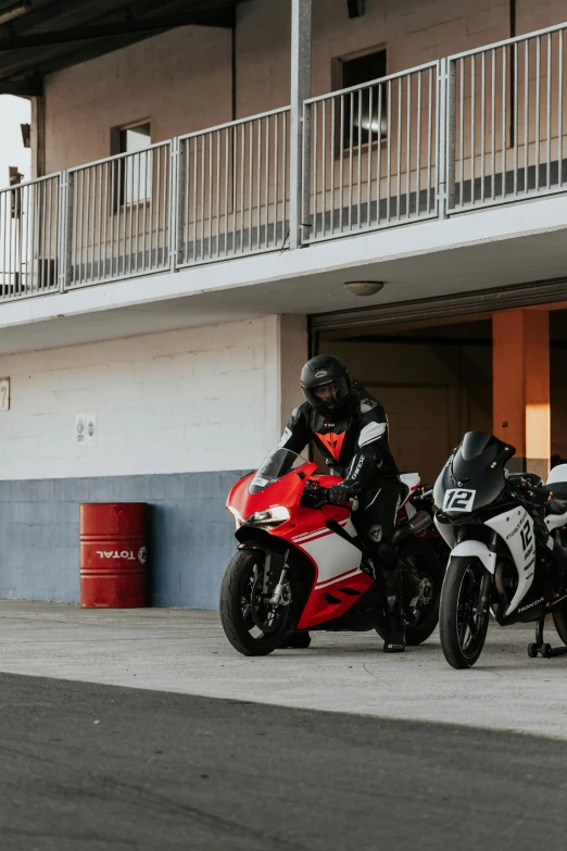 two motorcycles that are sitting out side of a building