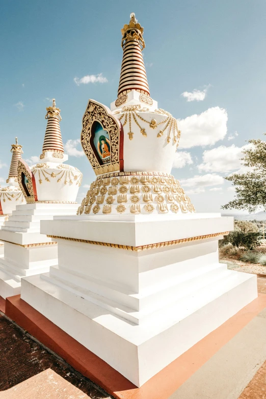 white buildings and golden spires in front of blue sky