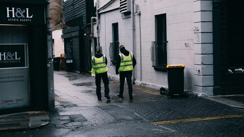 two police officers walking in front of a building