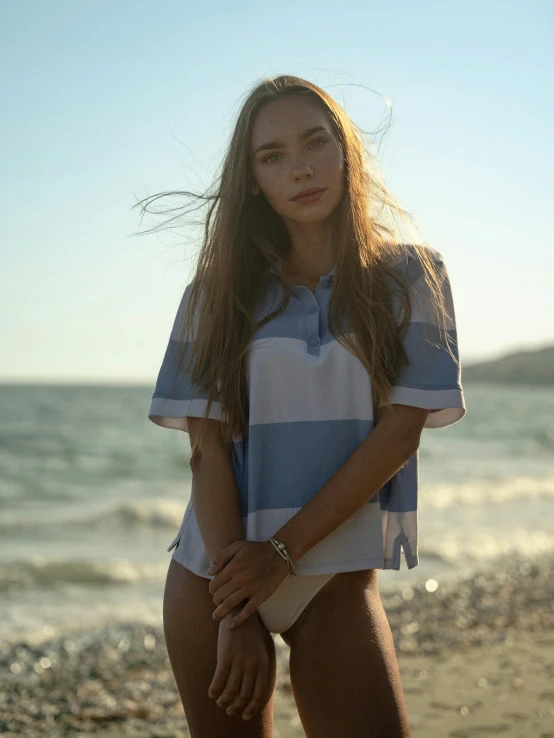 the woman stands in the water near a beach