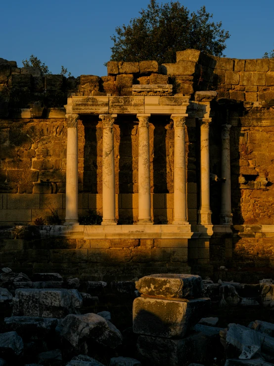 the ruins of a roman temple at sunset