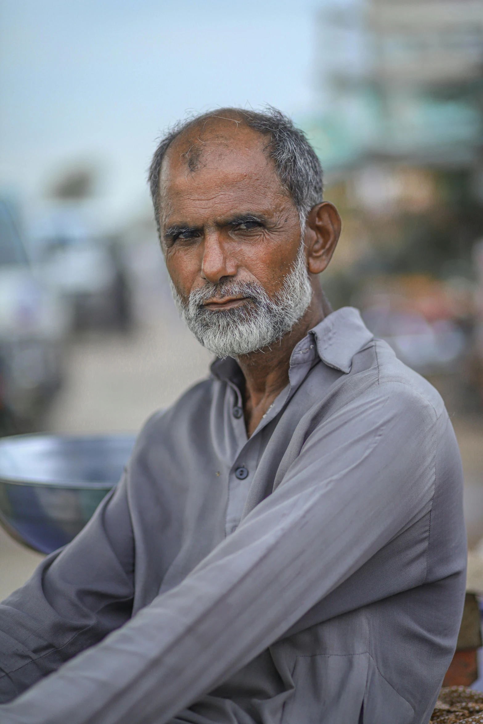 a man with a long white beard is sitting by himself