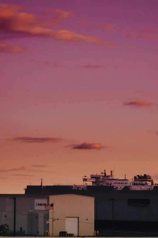 the sky is pink and purple, with clouds in it