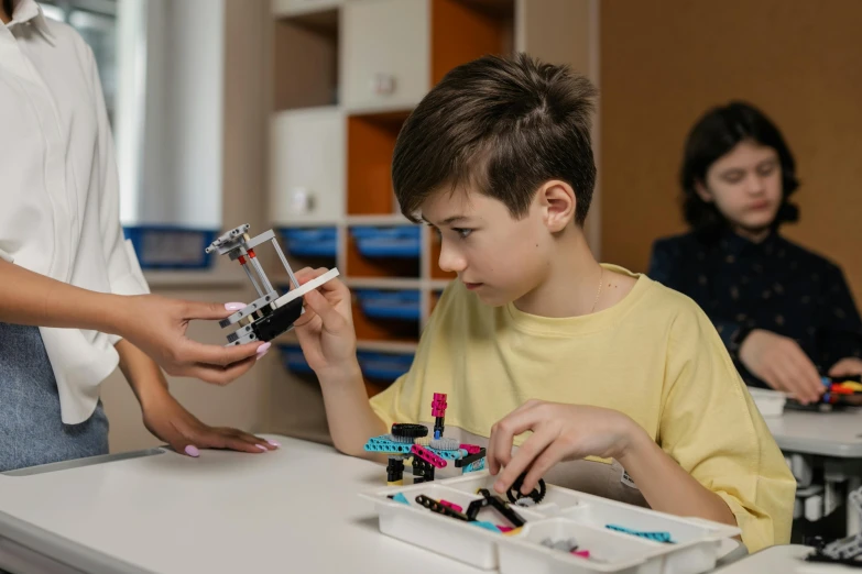 children play with small objects while others watch