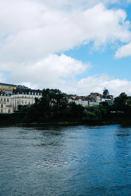 a boat travels down the river past some buildings