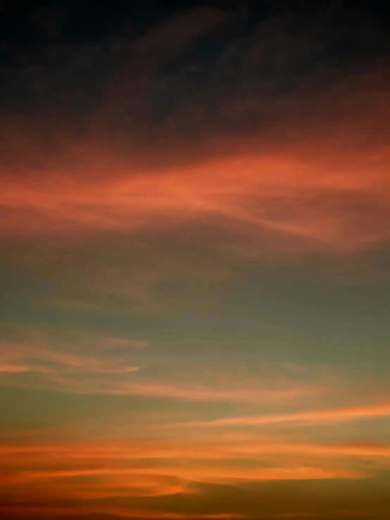 the sun sets behind an airplane in flight