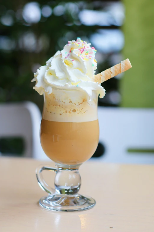 a drink with sprinkles and a straw sticking out
