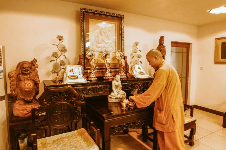 an elderly man preparing items for worship