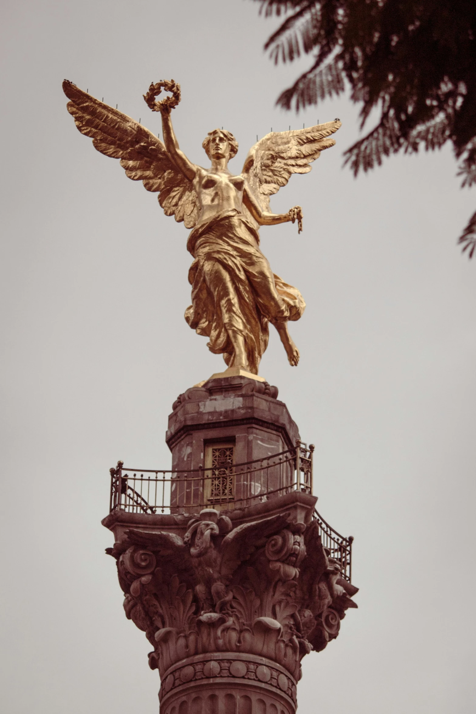 the gold statue is on top of the tower