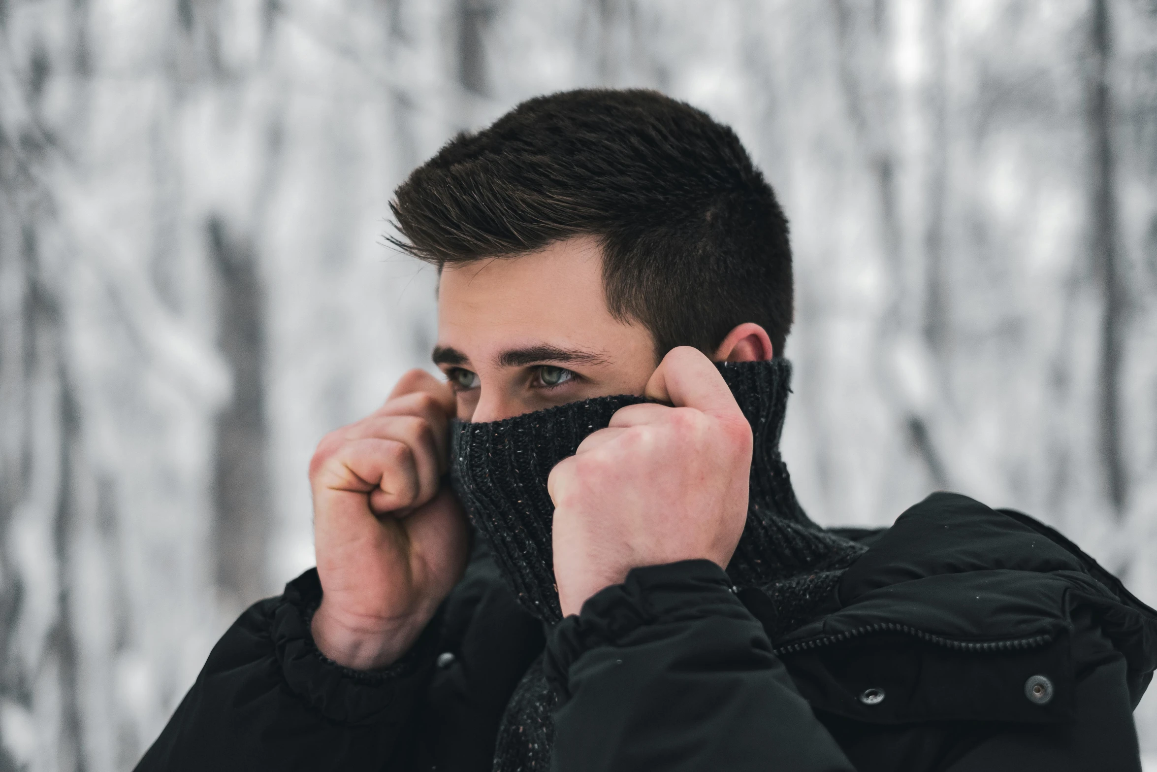 a man wearing a jacket talking on a cell phone