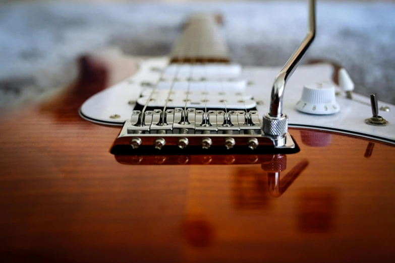 the bridge on a guitar sits next to the pickup on