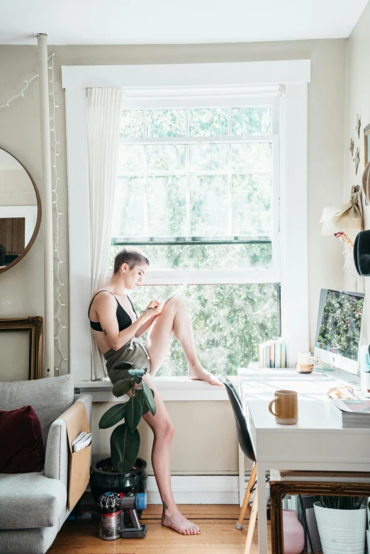 a woman sitting in her bed reading a book