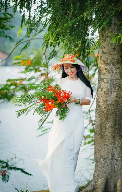 asian woman in traditional garb carrying a bouquet of flowers