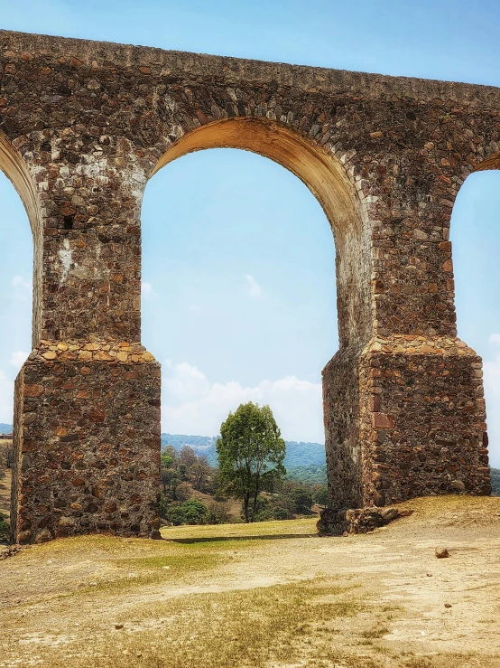 a stone wall and an archway shaped archway