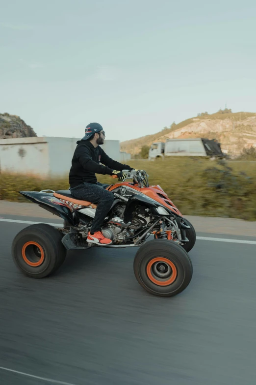 an person riding on the back of a four - wheeler