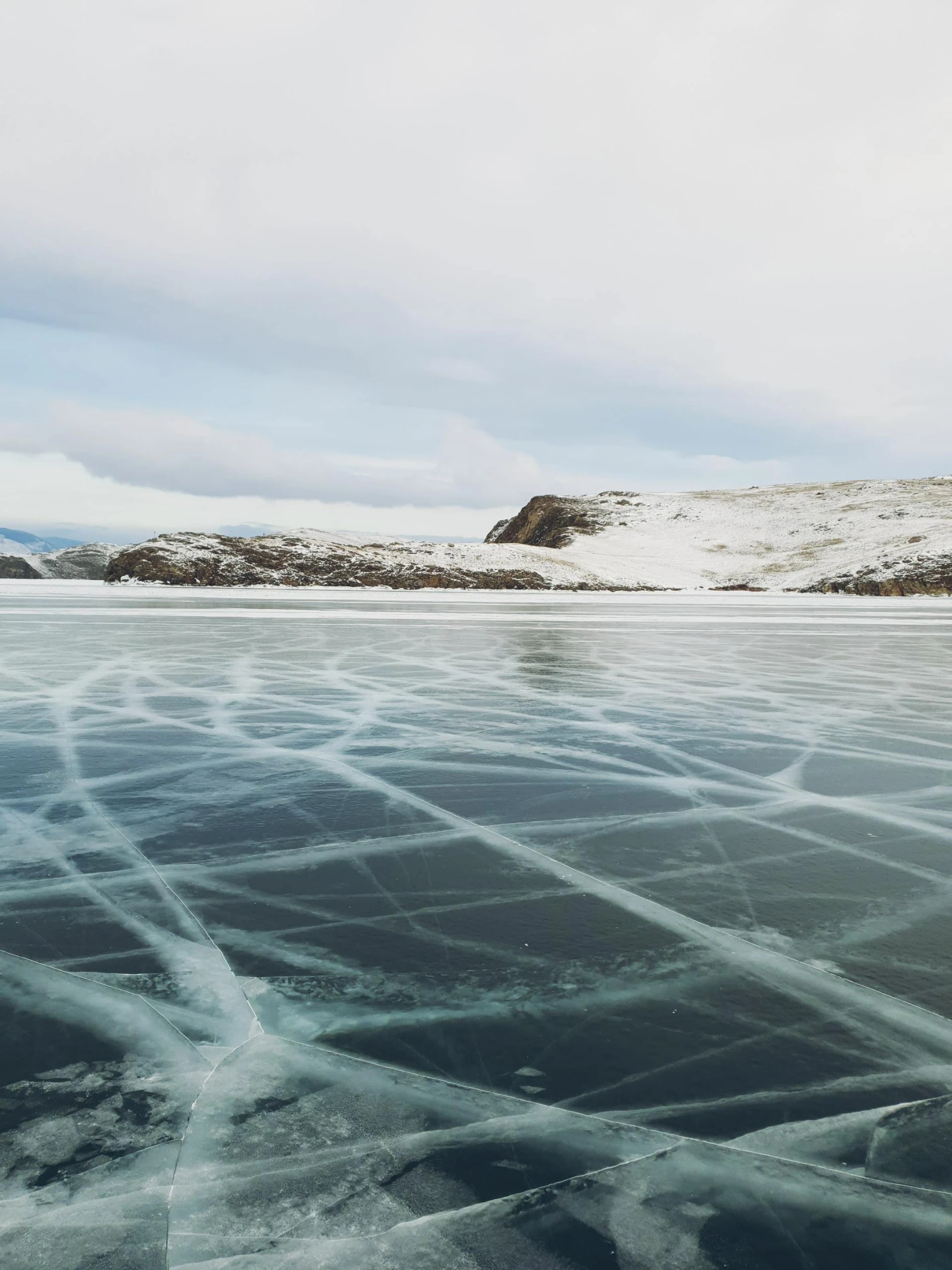 a landscape view of the water with thin ice