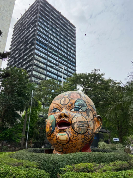 a very tall building sitting next to a garden and bushes