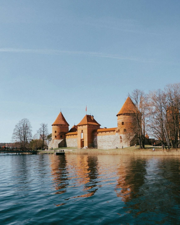 an old castle is perched on a island