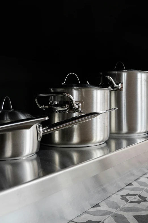 pots and pans are lined up on the counter top