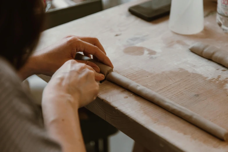 a person holding the edge of a piece of paper