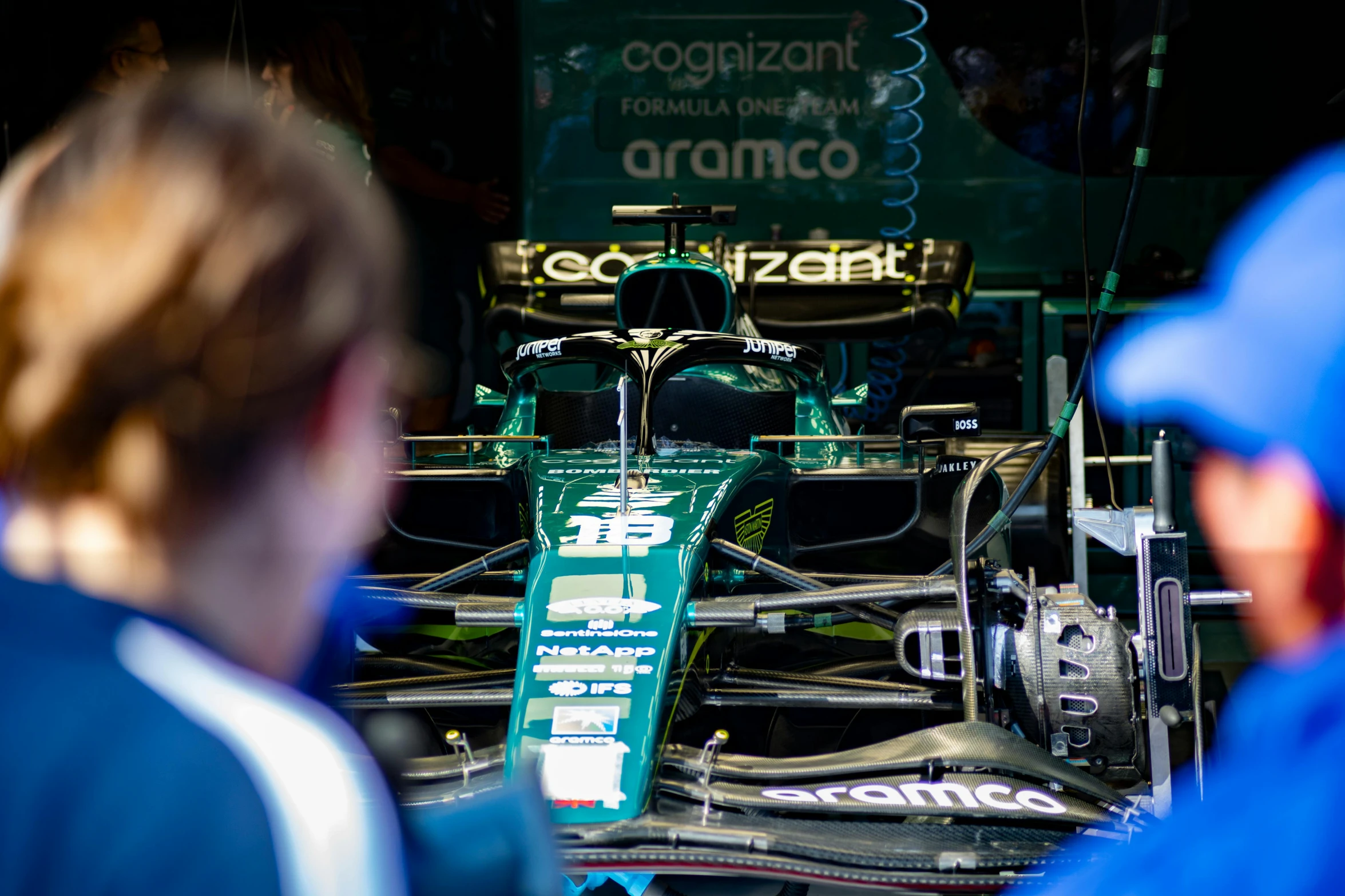 a race car is shown in front of the camera, with a person behind it