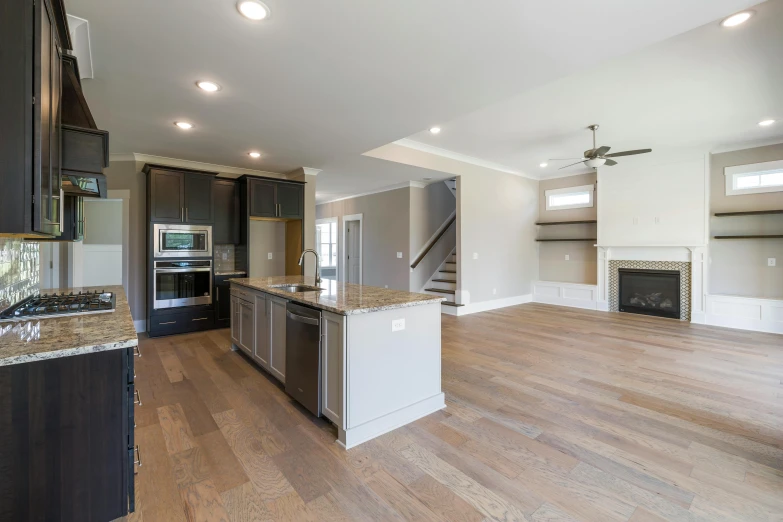 an open kitchen with a sink, oven, refrigerator and stove