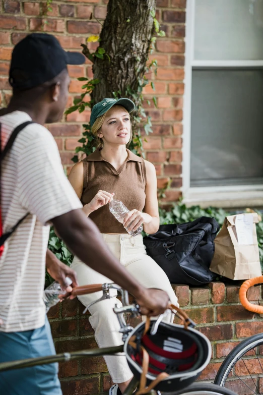 a man and a woman in hats are talking