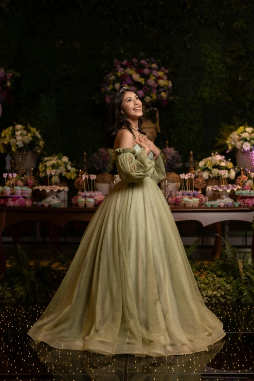 woman dressed in green dress posing for picture