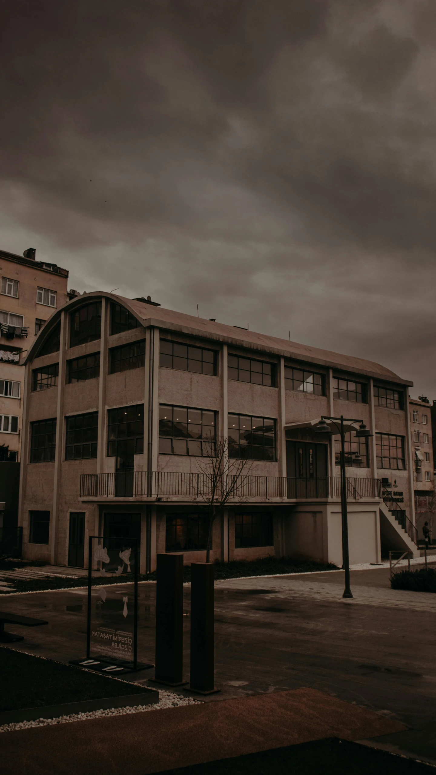 a large building with balconies on a cloudy day