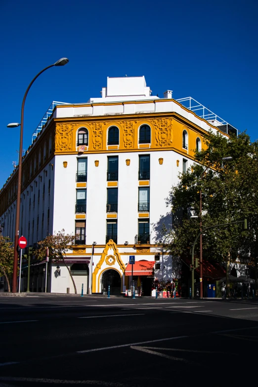 a large white and yellow building on a city street