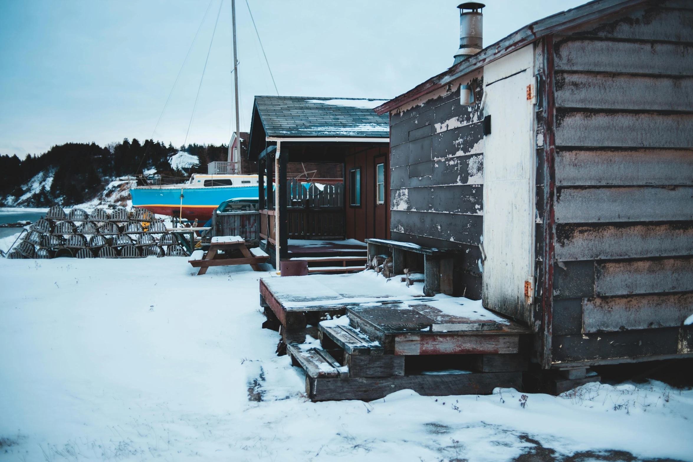 a small wooden building sitting on top of a snowy ground