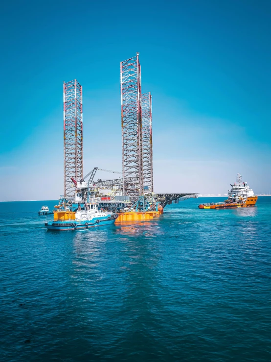 boats on the water with a tall metal structure in the middle