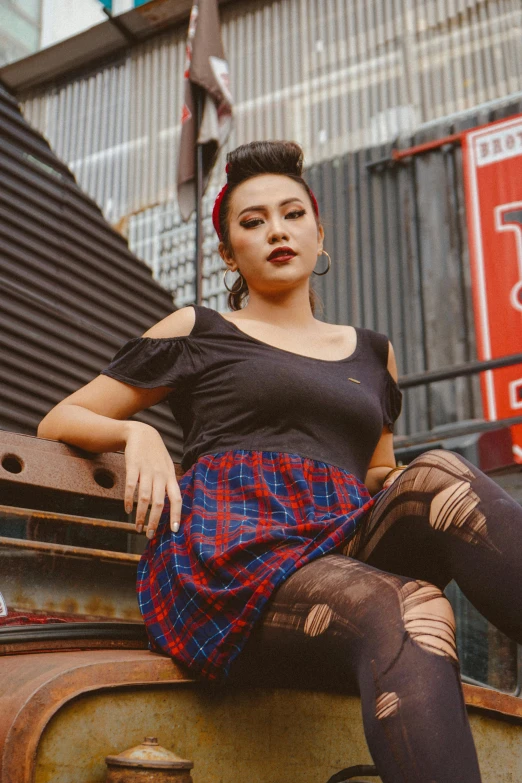 a woman sitting on a rusty dump truck