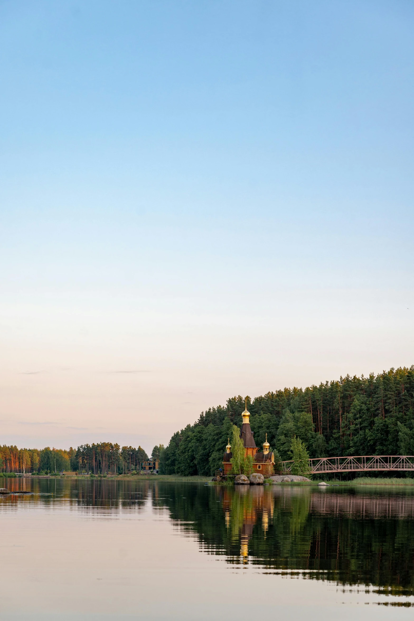 two people kayaking on a lake with houses in the distance