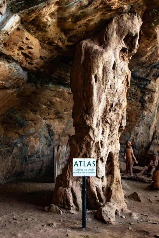 some people sitting in a chair near some large rock formations