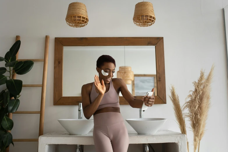 a woman standing in front of a mirror taking a selfie