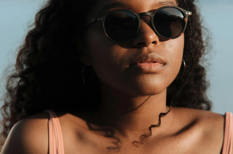 a woman wearing sunglasses is posing for a picture