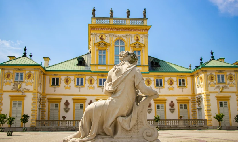 an ornate building with a large statue in front