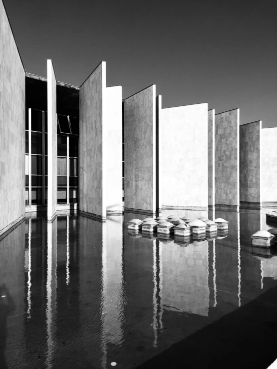 the exterior of a building, looking down at the water in front of it