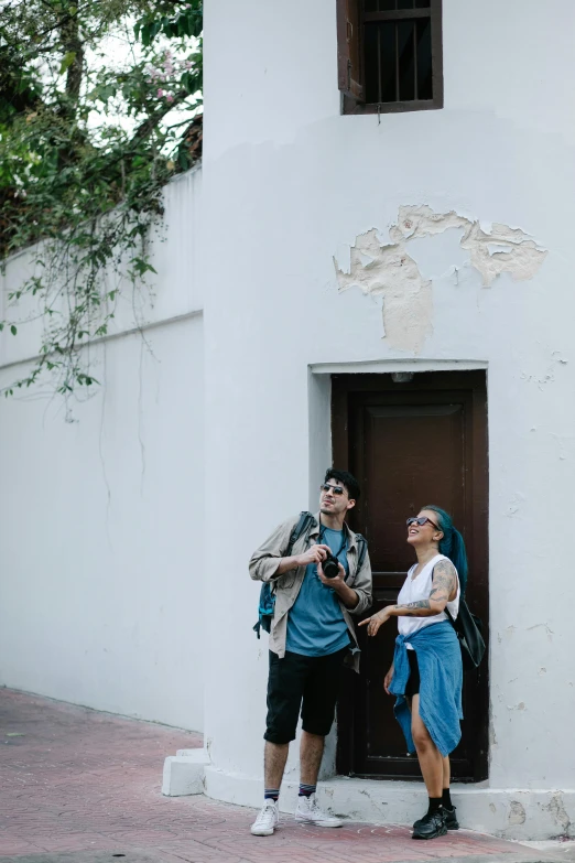 two people standing next to each other near a doorway