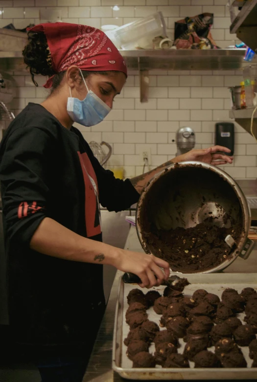 a woman is preparing chocolate cookies in a kitchen