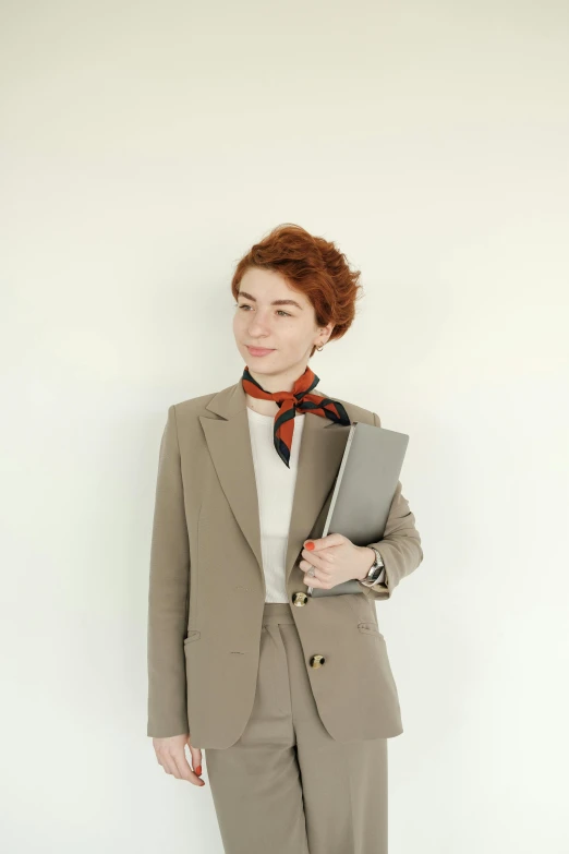 woman in business wear with red hair posing for the camera