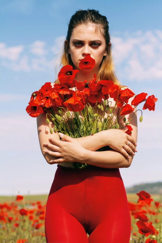 a woman standing in a field of flowers