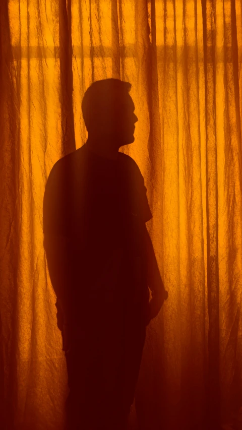 a silhouette of a man in the shadows