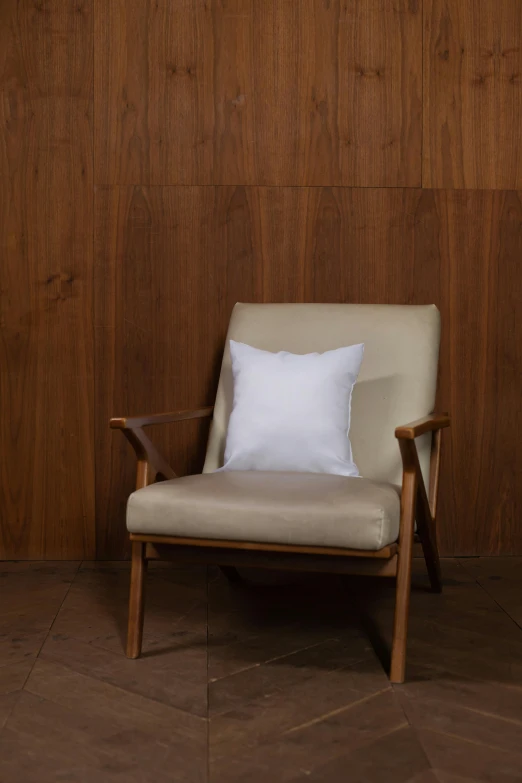 a wooden chair has a white pillow on it